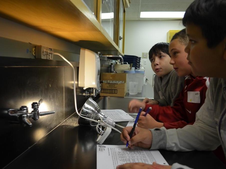 3 students monitor the energy use inside their school building