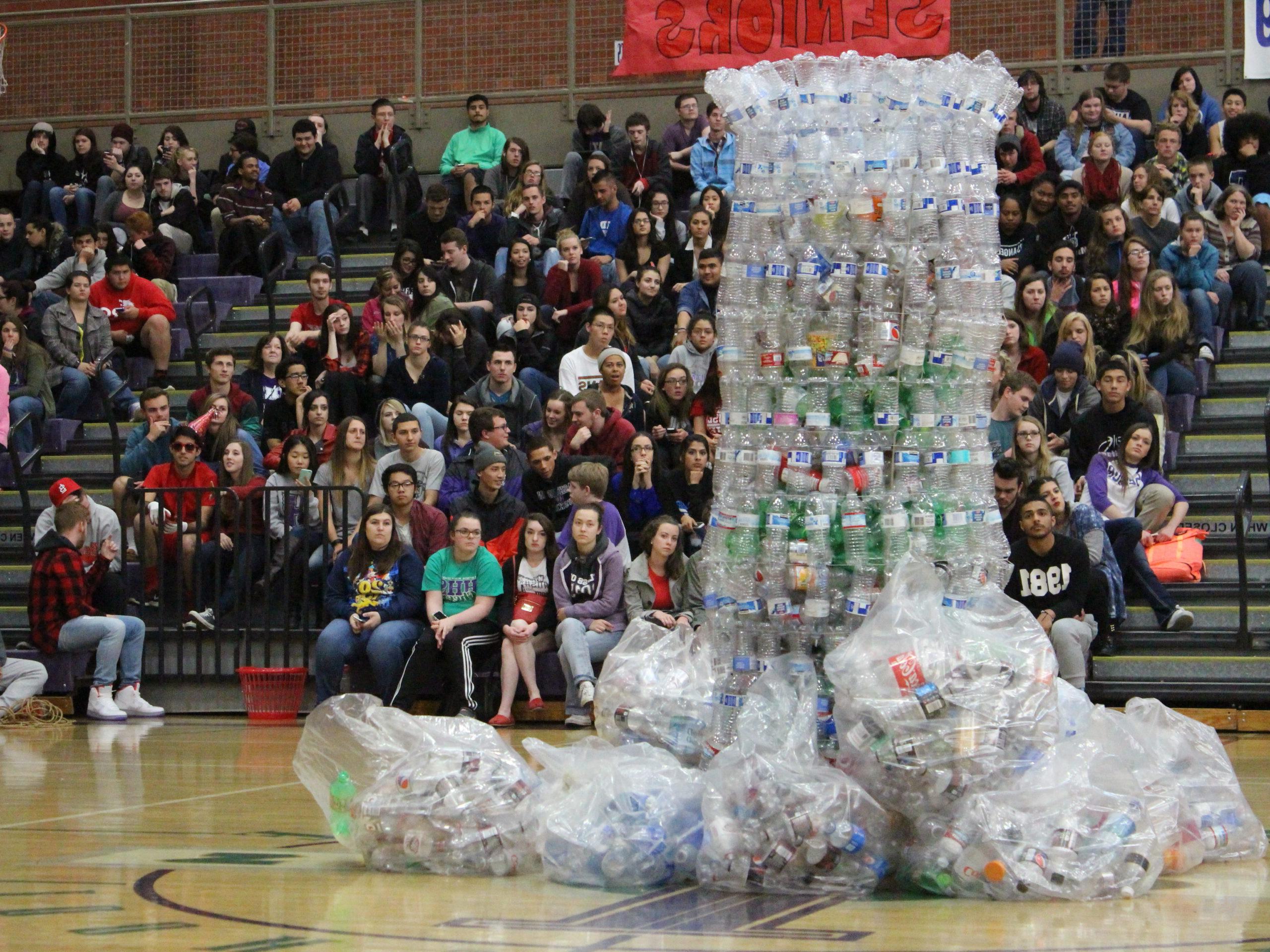 A large sculpture of plastic bottles in the middle of a gym